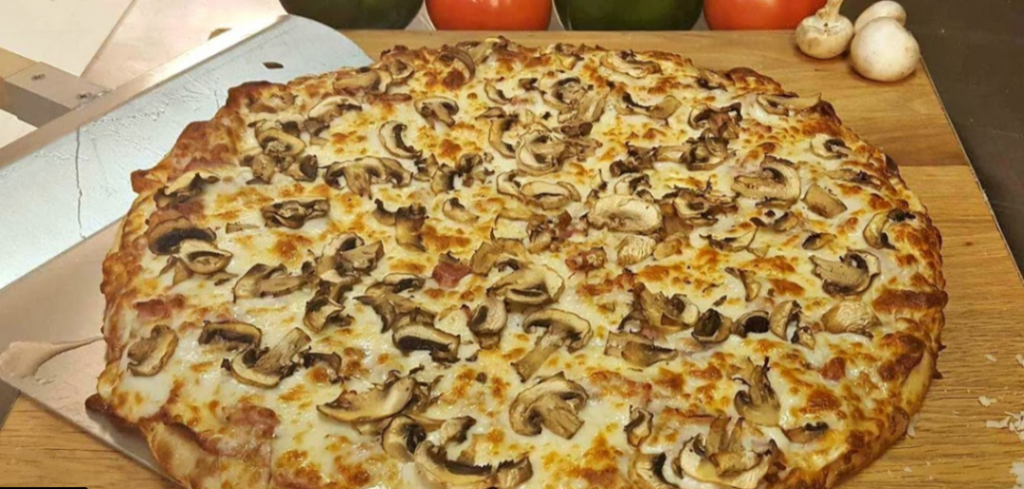 top view of pizza in box with mushrooms and cheese