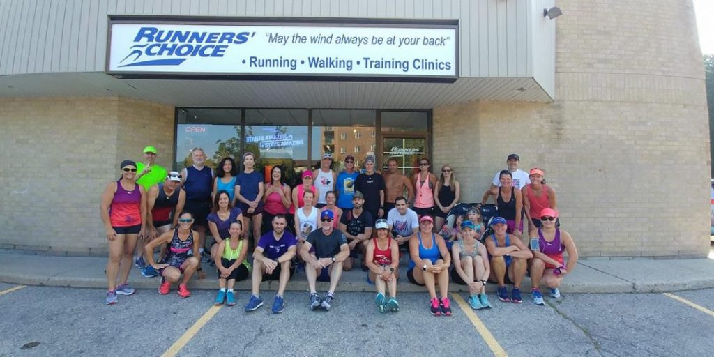 group shot of people in front of store front with people wearing athletic wear post workout