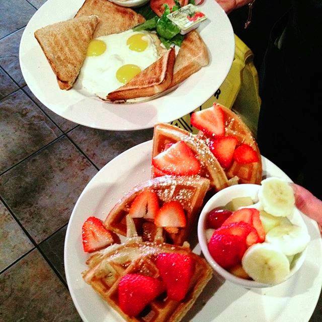 overview of two breakfast plates one with waffles the other with eggs