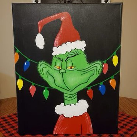 the grinch painted on a canvas against a wall