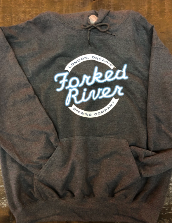 large dark grey hoodie with brewery logo on the front with sleeves tucked into pockets