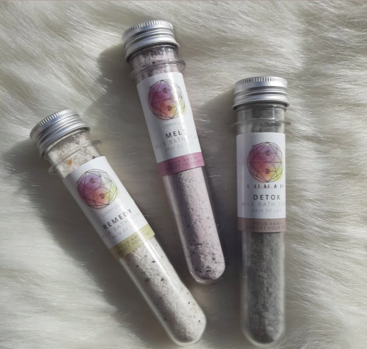 three 'test tubes' of bath soakes of different varieties on white faux fur