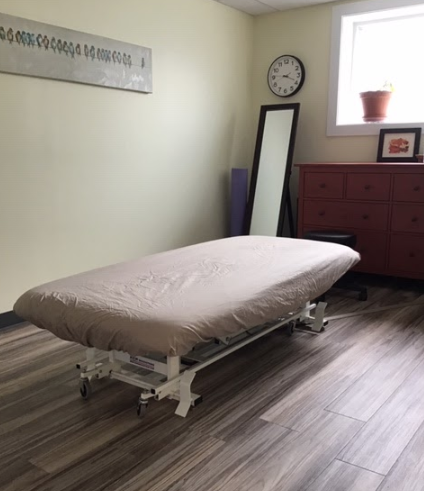 interior of a massage room with a half made bed