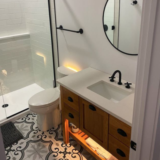 interior of a recently renovated bathroom with wood, white, and black accents throughout the bathroom