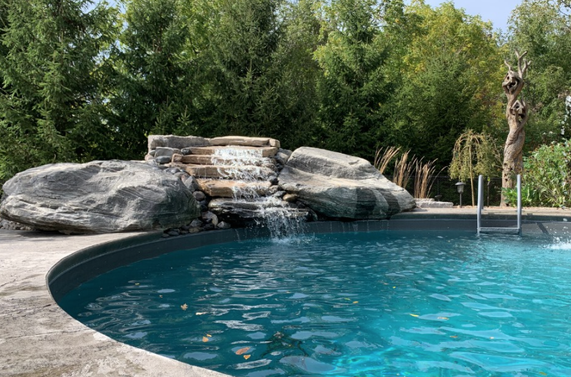 pool with a large rock fountain feature