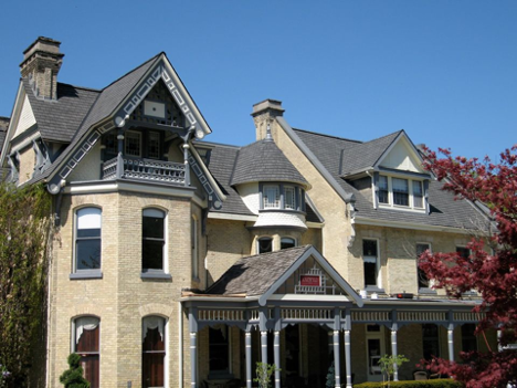 exterior of a large house with different levels and areas on a sunny day