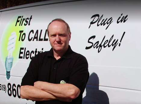 man posed in front of a trades work van with arms crossed looking at the camera