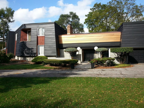 exterior of an interesting style house with metal roofing coming over the front of the house