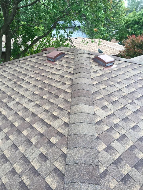 close up of grey and brown shingles on a roof