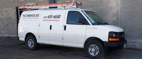 a white work van with company name and phone number on the side with a ladder attached to the roof rack