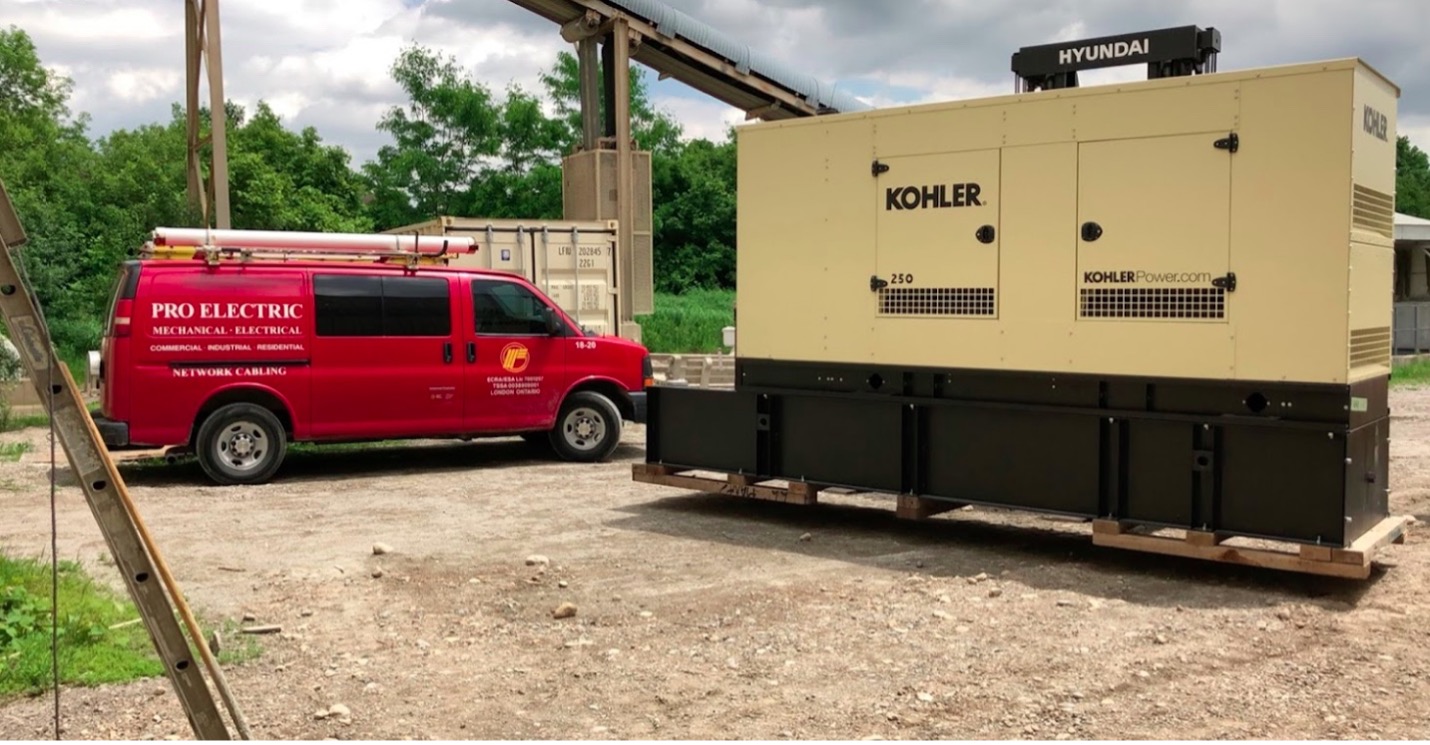 red work van parked at a job site with a large generator beside it