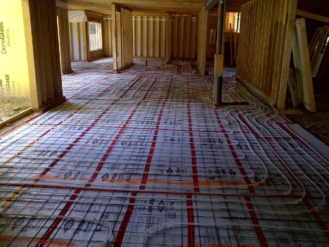 empty house that is under construction that has many pipes along the floor