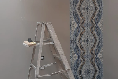 ladder set up in a room with a painting sponge sitting on one of the levels with a pattern painted in the background
