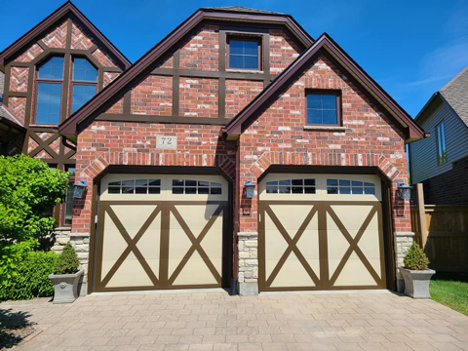 exterior of a house with focus on the newly painted garage doors in beige and dark brown