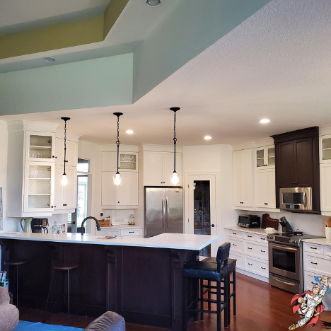 a large kitchen that was recently painted in blue, green and white