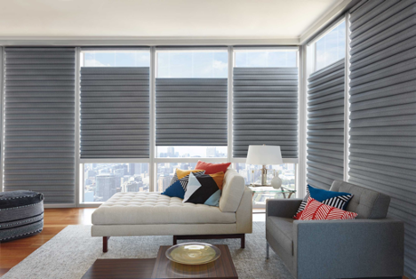 Small living with grey blinds on corner style windows at various levels