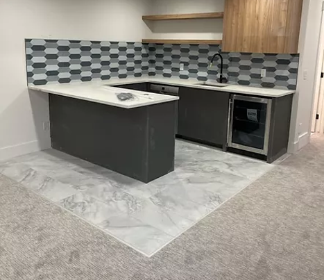 newly renovated kitchen with tiling then carpet in living room