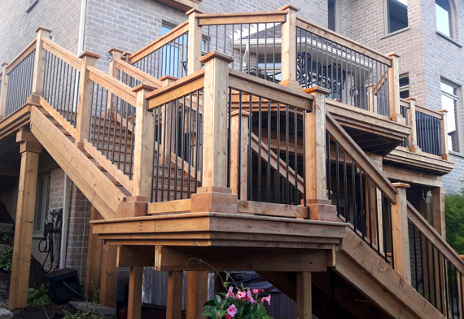large deck with winding staircase with iron rods in the middle