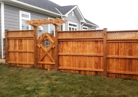 backyard fence with entryway to the left with a small archway