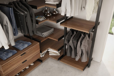 Interior of closet with custom cabinets with shirts shoes and other items