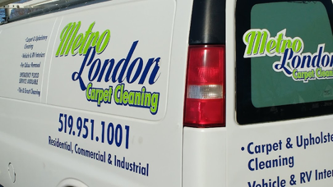 White work van with company details on the side in blue and green