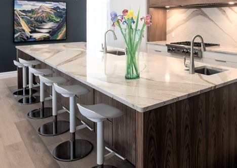 beige granite countertop on kitchen island with bar stools set for dining