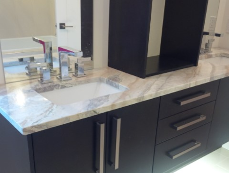 bathroom countertop with marble pattern and dark cupboards