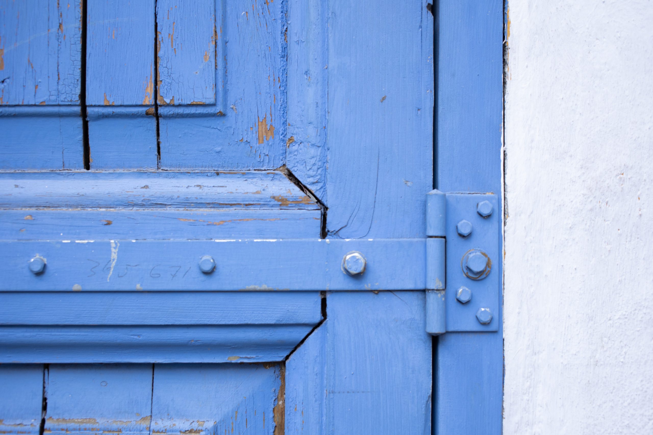 blue door with blue hinges
