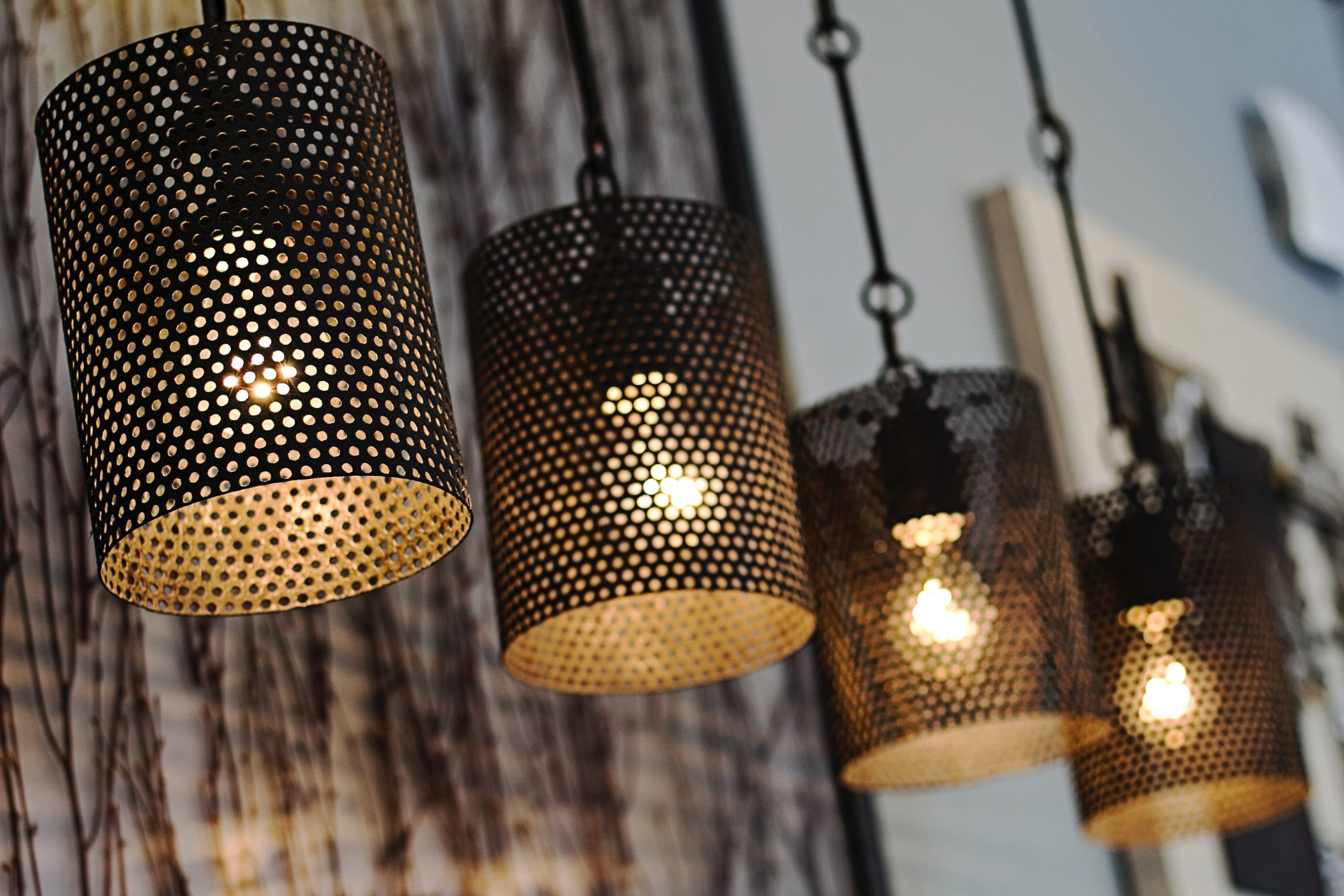 three hanging pendant lights with polka dot design painted black