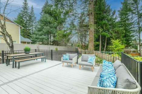 outdoor deck with seating area and picnic table being iron gates