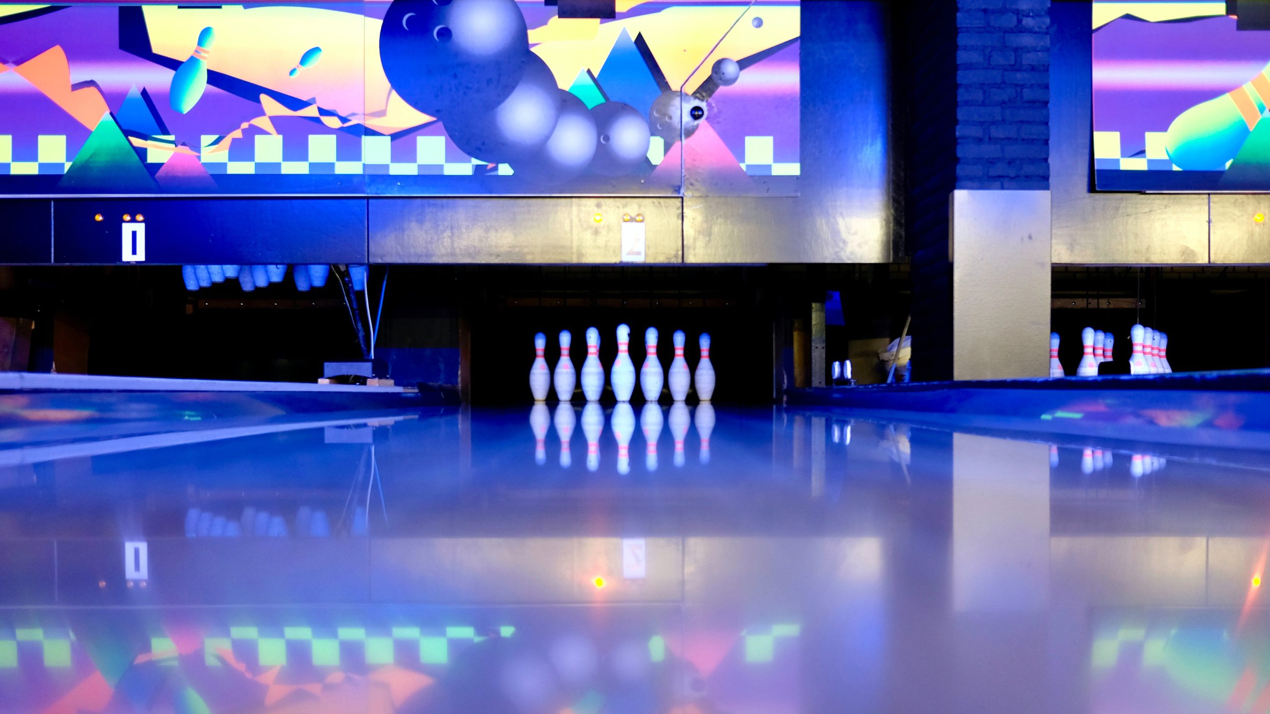 Bowling lane with neon lights and all pins up
