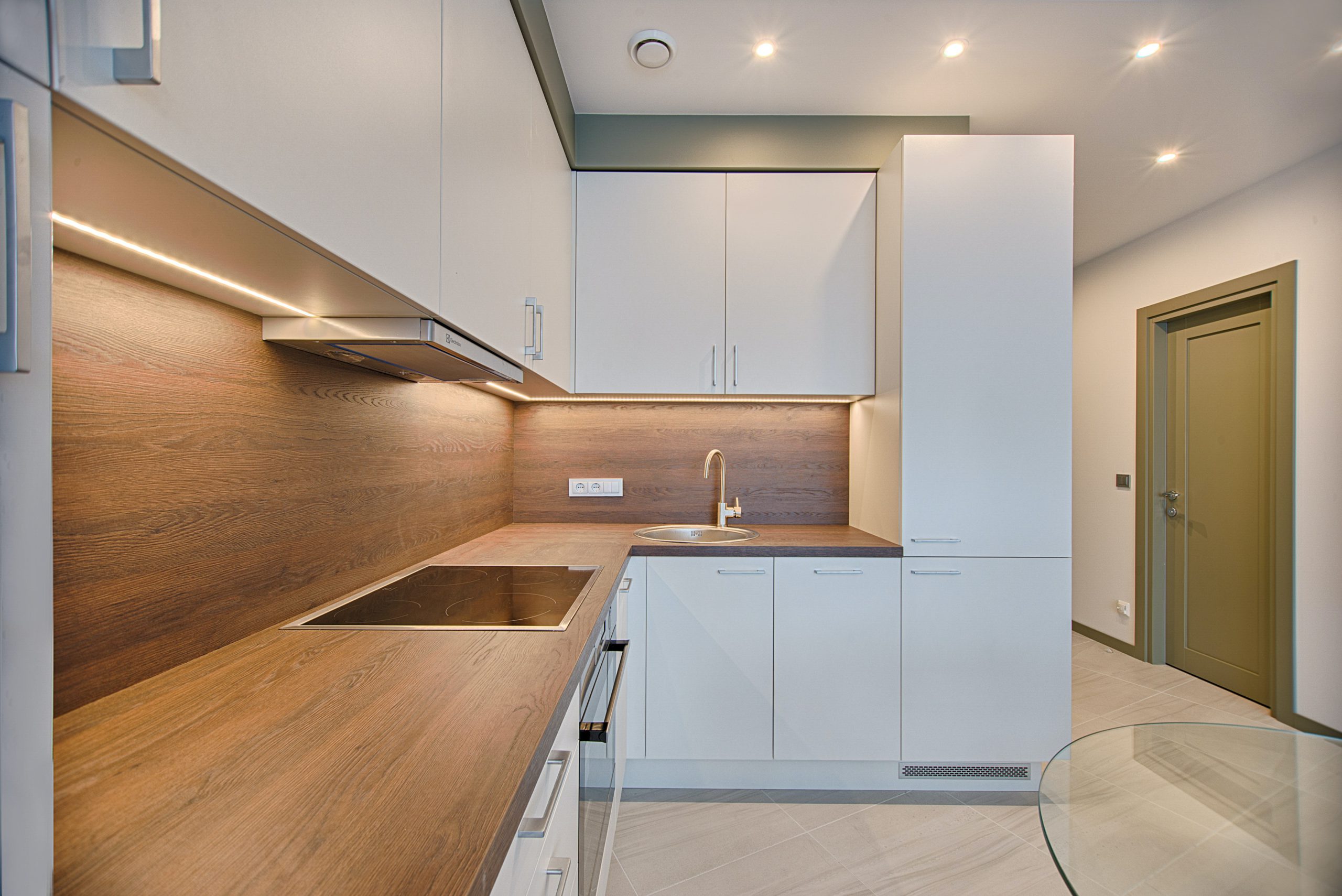 Modern kitchen with nothing on wooden style countertops and minimalist cupboards