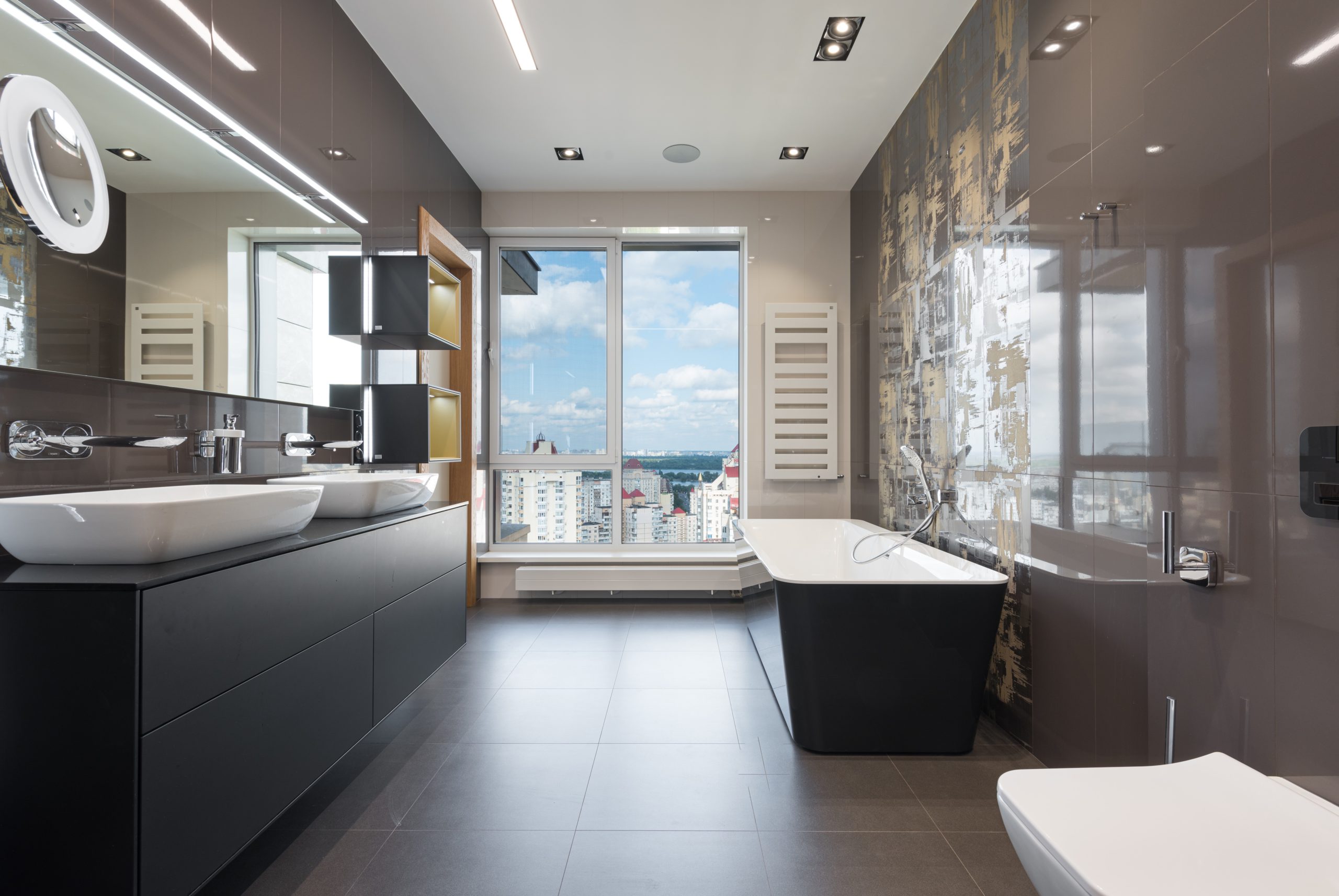 Modern homes bathroom with view outside with dark vanity