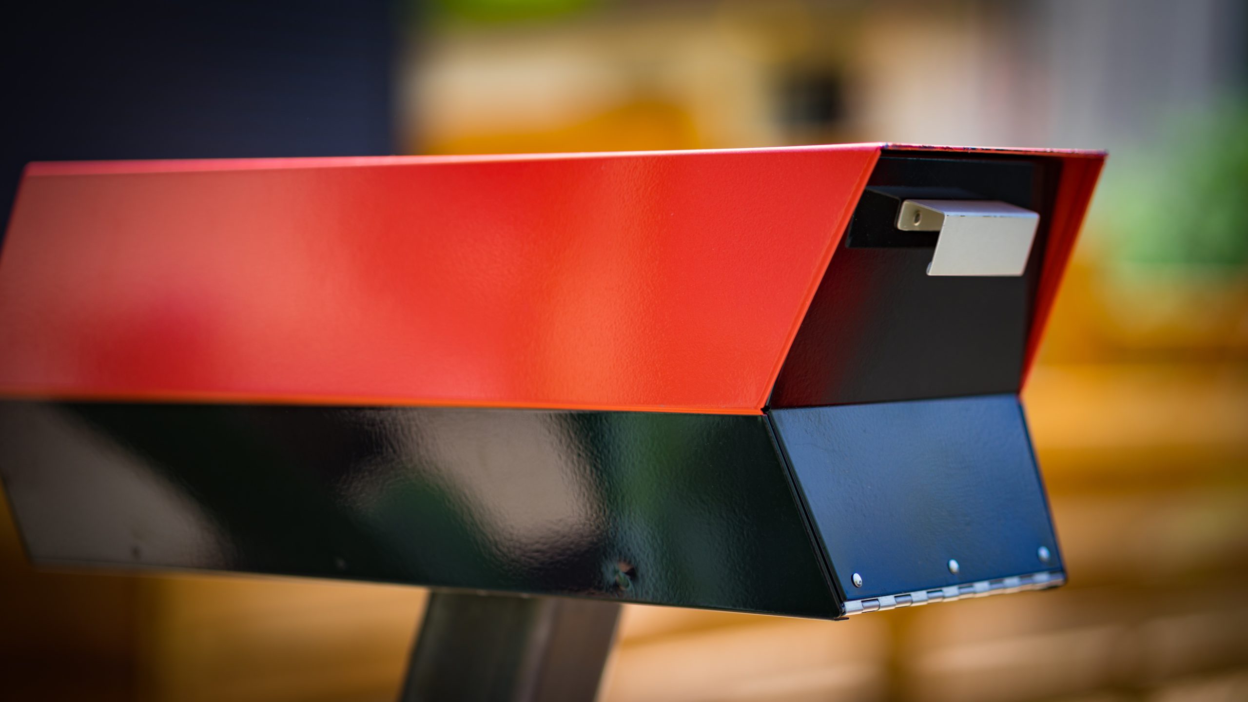 Modern mailbox with red and black paint