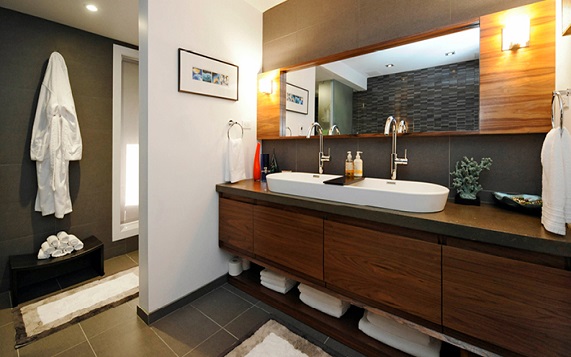 modern bathroom with wooden vanity and hallway view