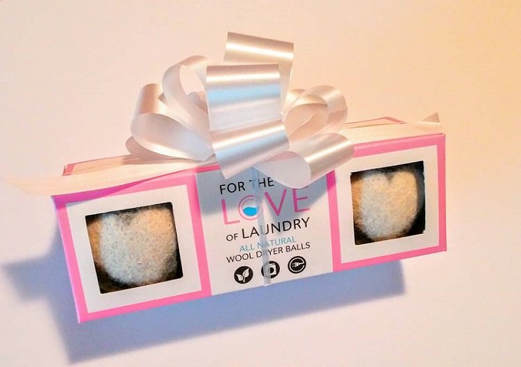 dryer balls in gift wrapped package with bow on white background