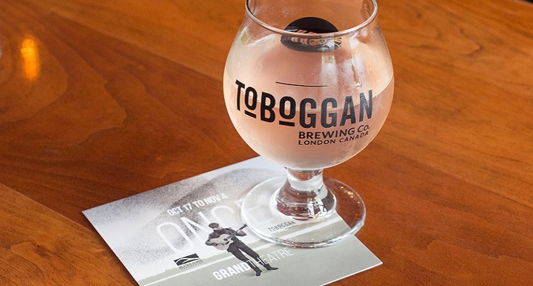branded Glass at Toboggan Brewing Co. on top of coaster filled with water