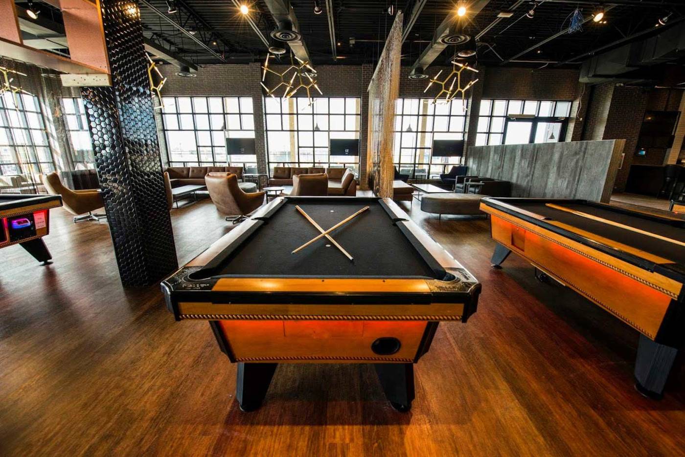 pool tables and chairs in arcade with no patrons