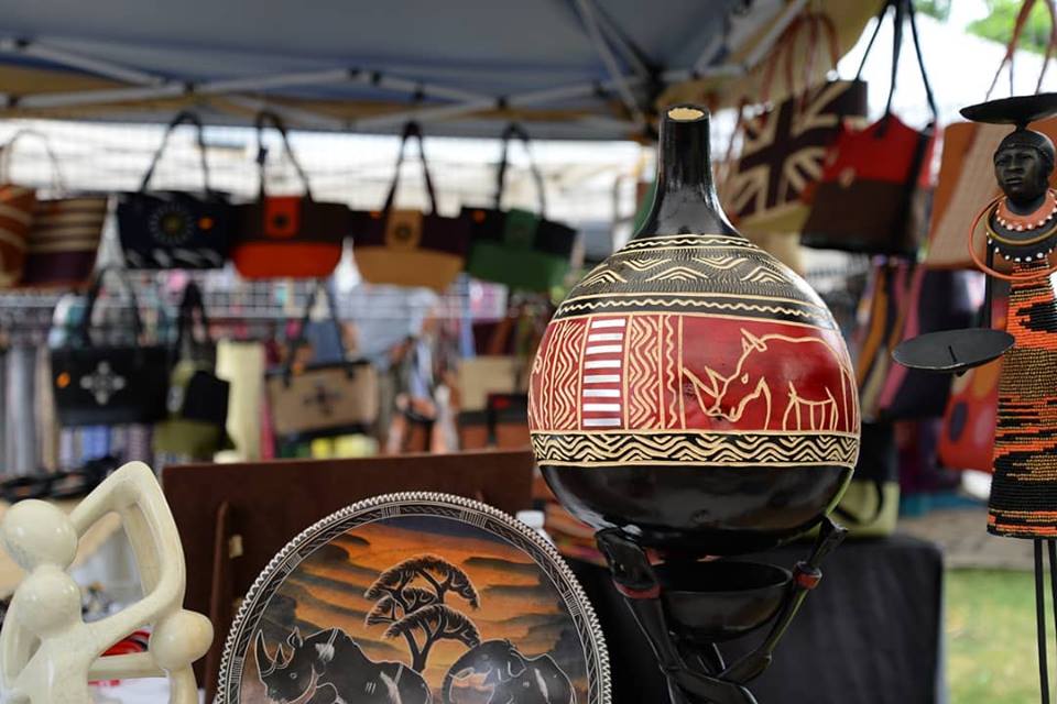 closeup of cultural ornaments sold at a festival or market under tent