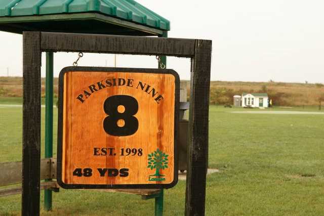 golf course hole 8 sign with yardage and rain structure in background