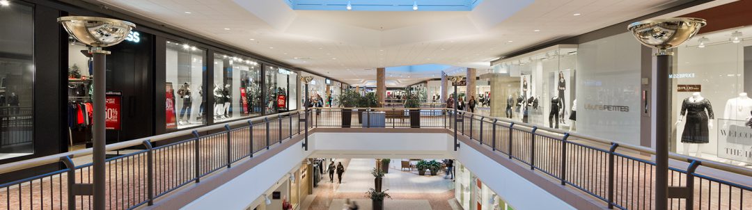 Interior shot of mall from the second level with stores surrounding and skylights visible