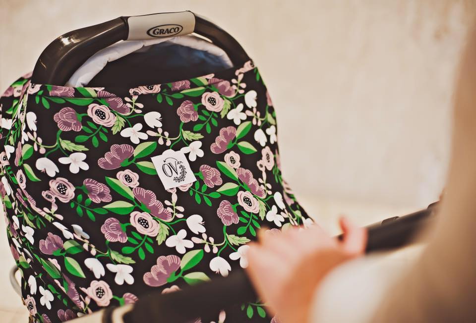 close up of baby stroller with flower print material wrap to enclose baby