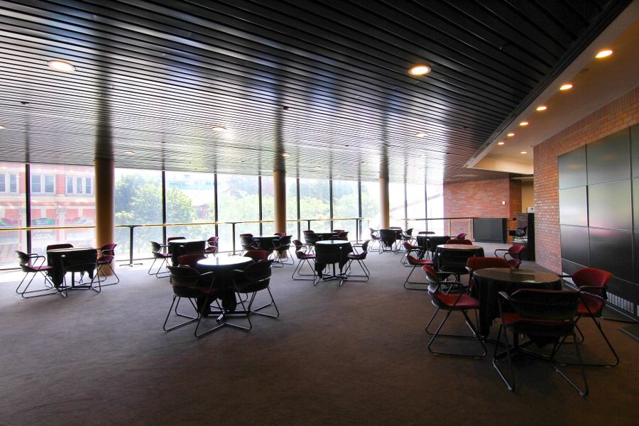Lounge are at a theatre with large glass windows towards the back