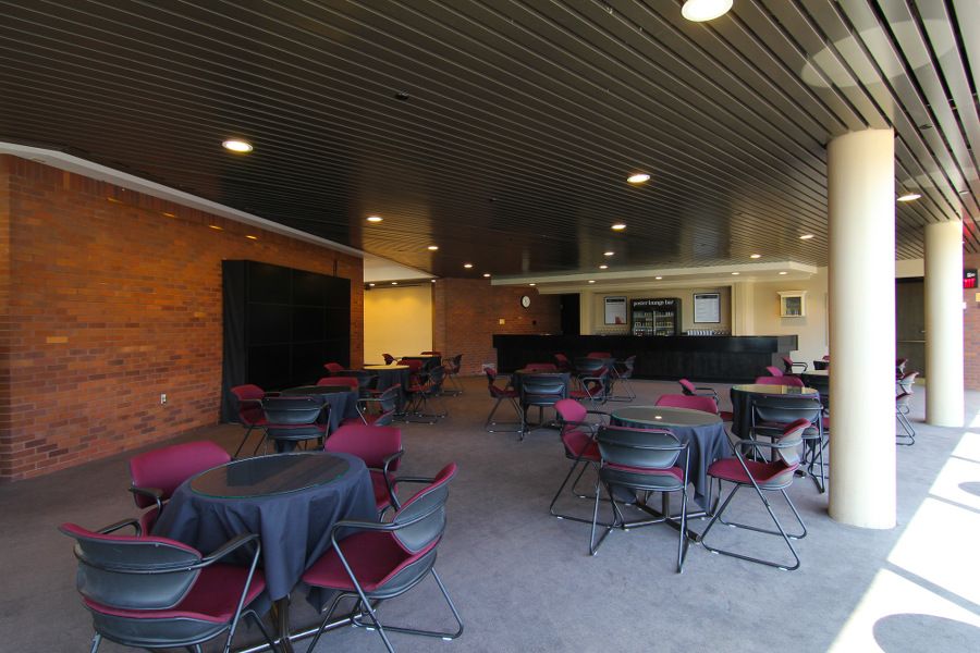 Lounge with empty red seats and tables under pillar platform