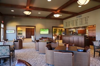 inside dining room with many large lounge chairs and golf clubs hanging off of top wall