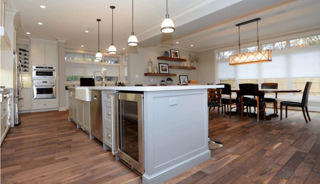 interior of modern kitchen looking from kitchen toward dining area with dark brown hardwood floor