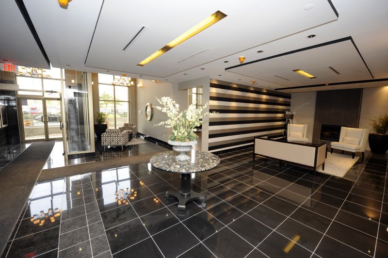 interior of modern foyer with black and gold finishes looking towards front entrance