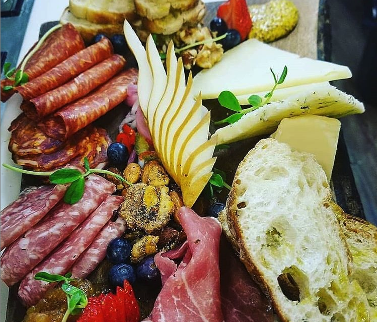 charcuterie board with meat cheese and vegetables