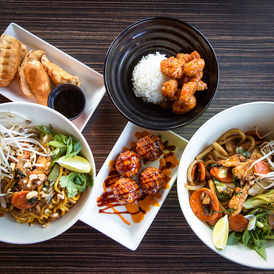 variety of asian food top view on a dark wooden table