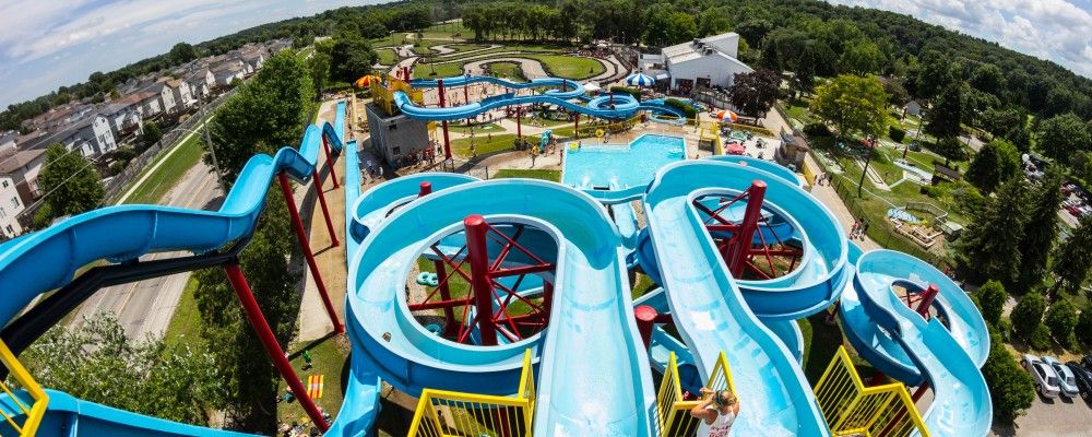 view from top of waterslide at a park with a community to the left